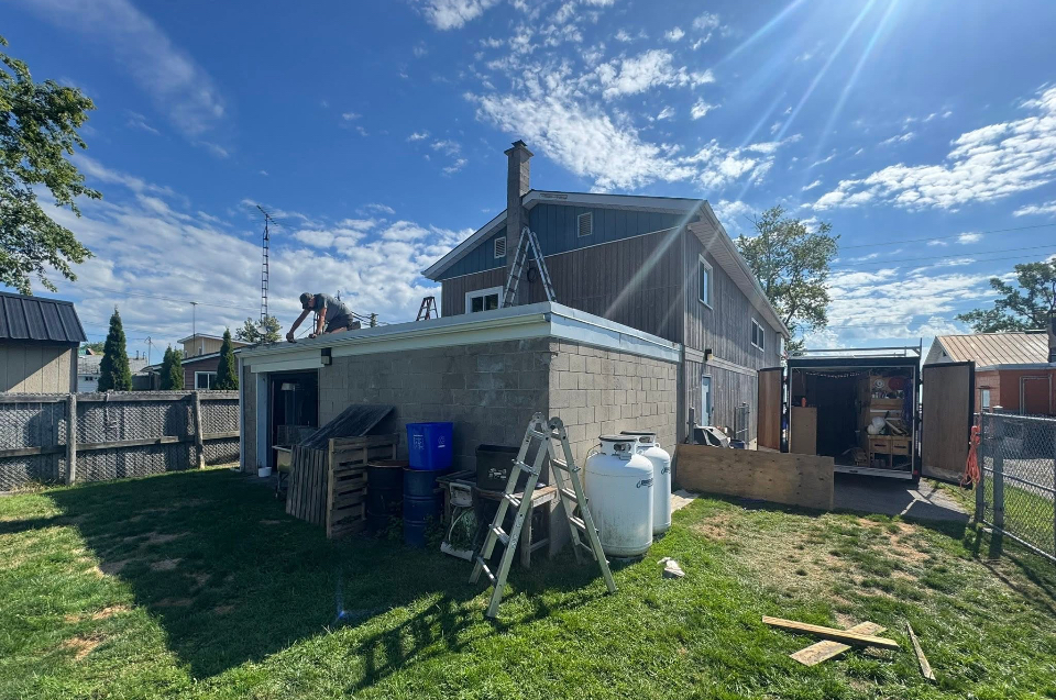 Before: block garage addition with new flat roof deck structure under construction by Kuiper Construction